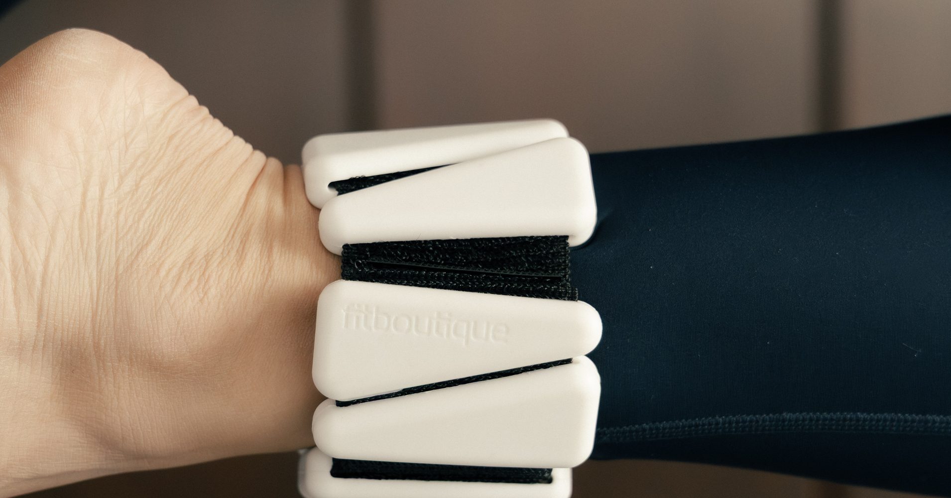 Close-up of a FitBoutique wrist weight worn during a reformer session