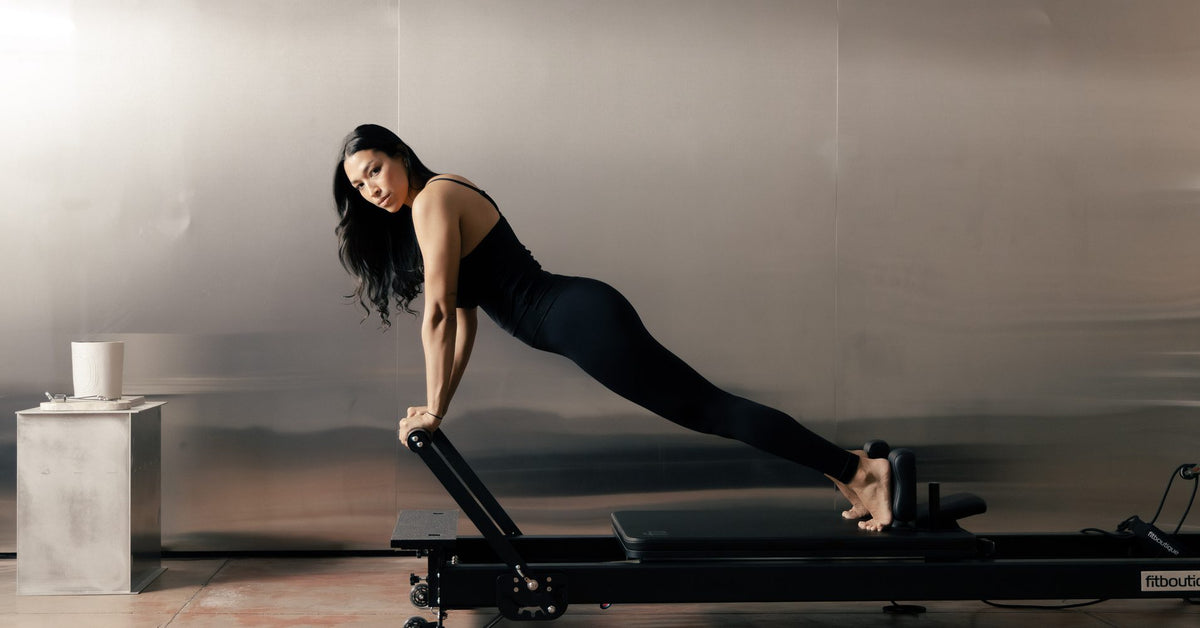 Long stretch plank on a black FitBoutique reformer